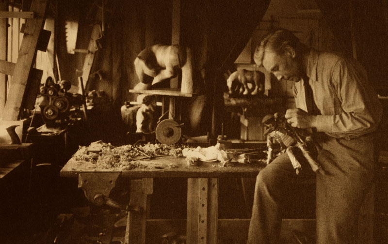 Archive image of William Simmonds in his Gloucestershire studio in 1925. The Black Mare can be seen in the background. Simmonds also carved puppets, and he and his wife, Eve Peart, ran a puppet theatre from about 1919 up to the 1930s.