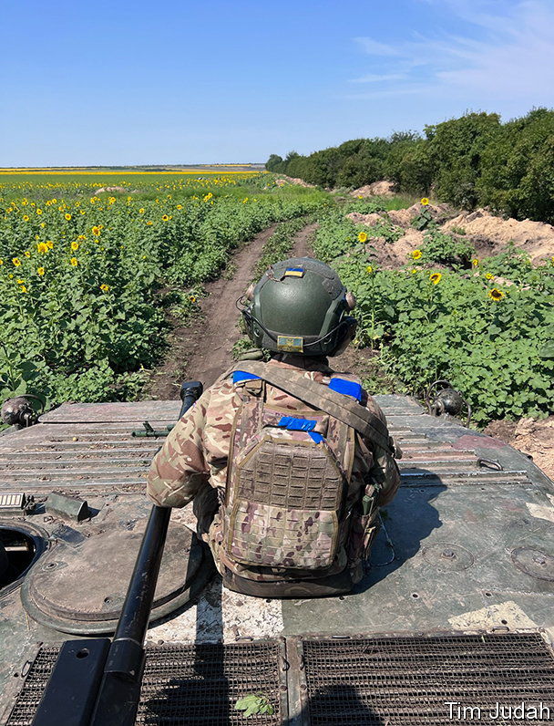 Ukrainian soldier rides on vehicle