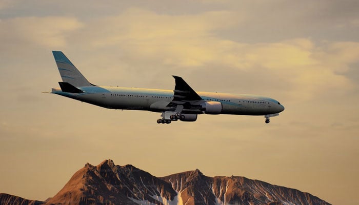 This representational image shows a passenger aeroplane during its flight over a mountainous region. — Unsplash